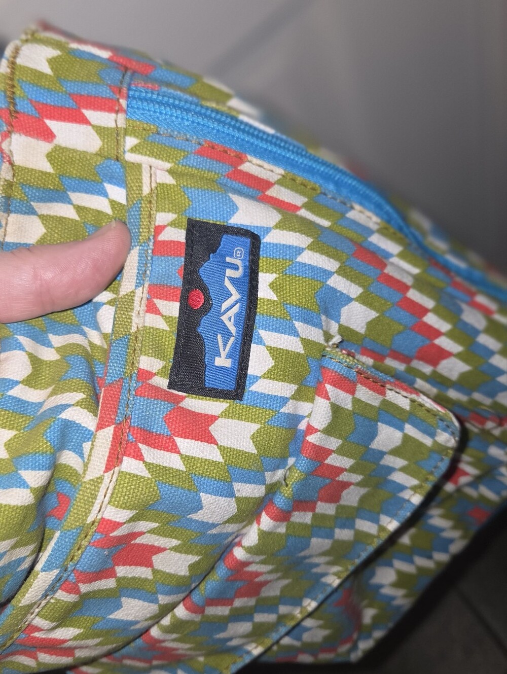 Kavu Multicolor Geo-Print Canvas Bag with Blue Zipper for making It expandable.